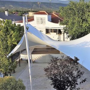 tensile cover with the shape of a hyperbolic paraboloid that covers the square of the town hall 